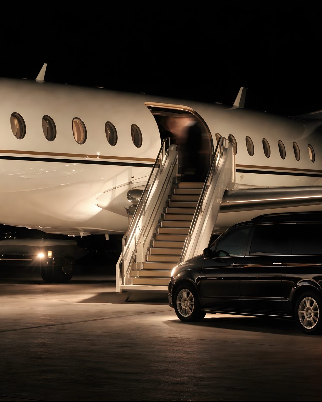 Private jet and chauffeured car at night